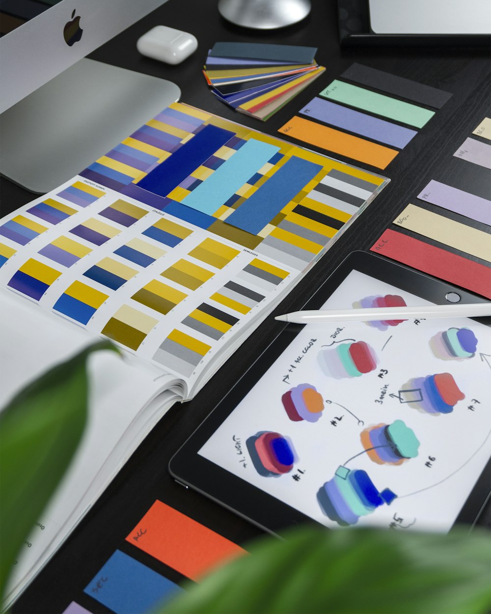 Brand design tools and color swatches on a desk